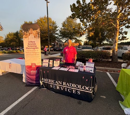 Community members spreading breast cancer awareness at a local event