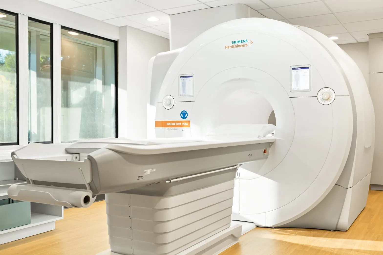 3T MRI scanner in an MRI suite with large windows